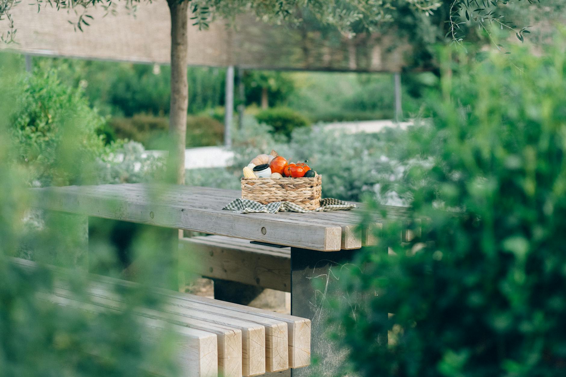 fresh vegetables on a woven basket on table top in tilt shift lens