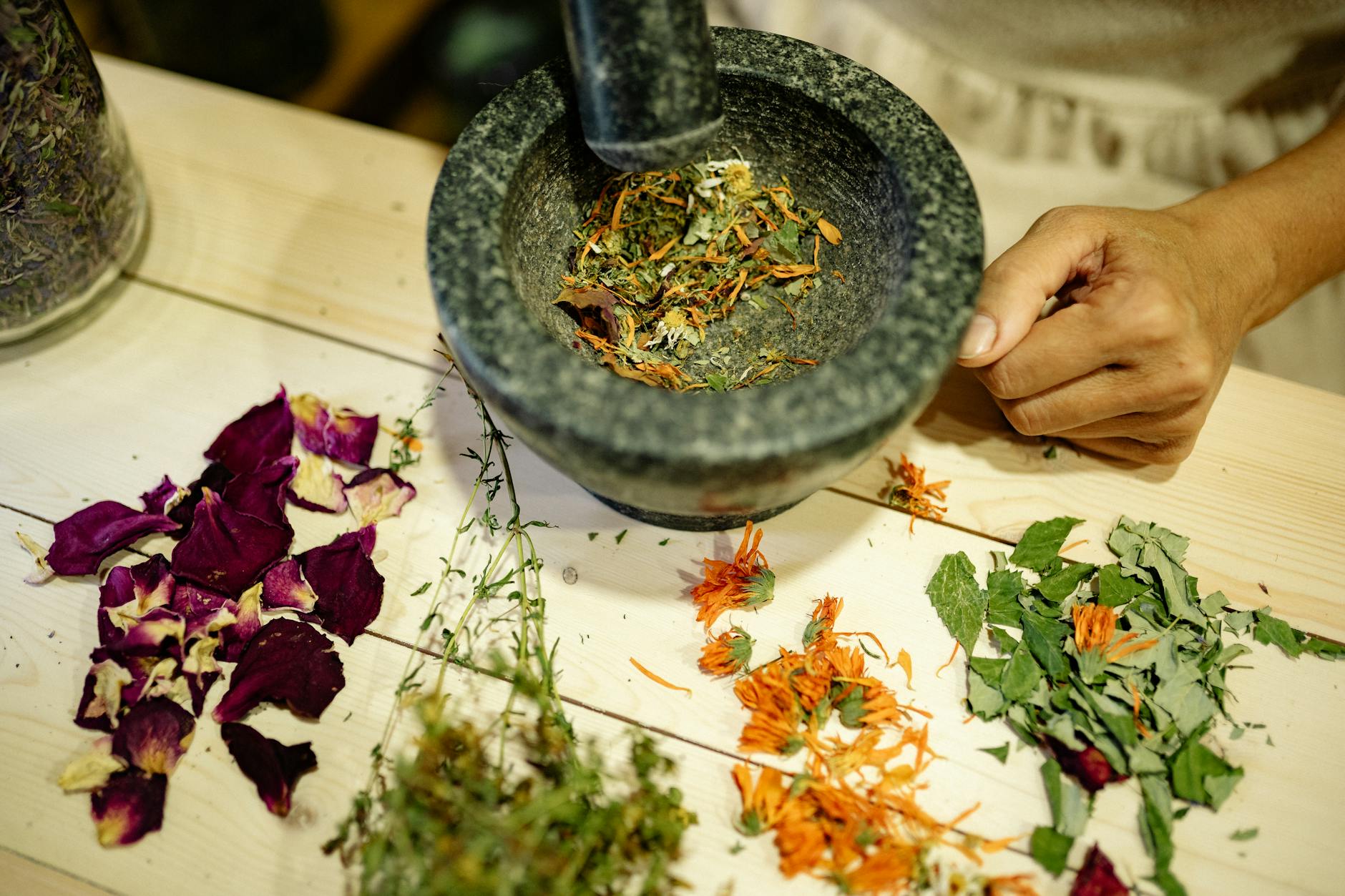 pounding petals and leaves with a mortar and pestle